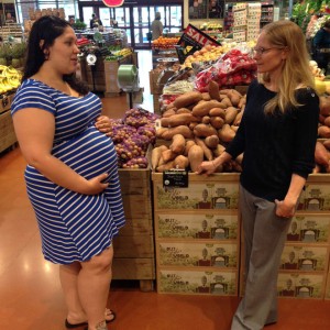 pregnant student speak with Cynthia Curl in produce section of grocery store