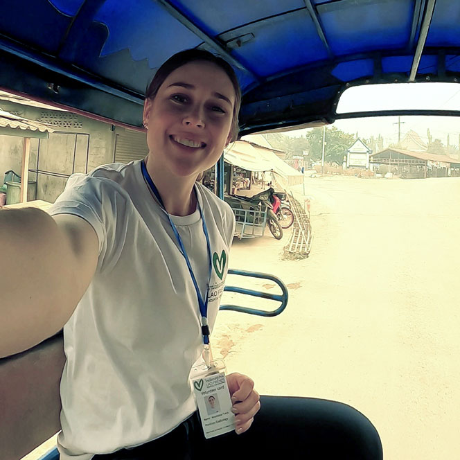 Anastasia Tracy in the back of a carriage in Laos