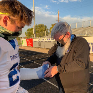 Tony Fitzpatrick adjusts wrist wrapping on Timberline high schooler's wrist