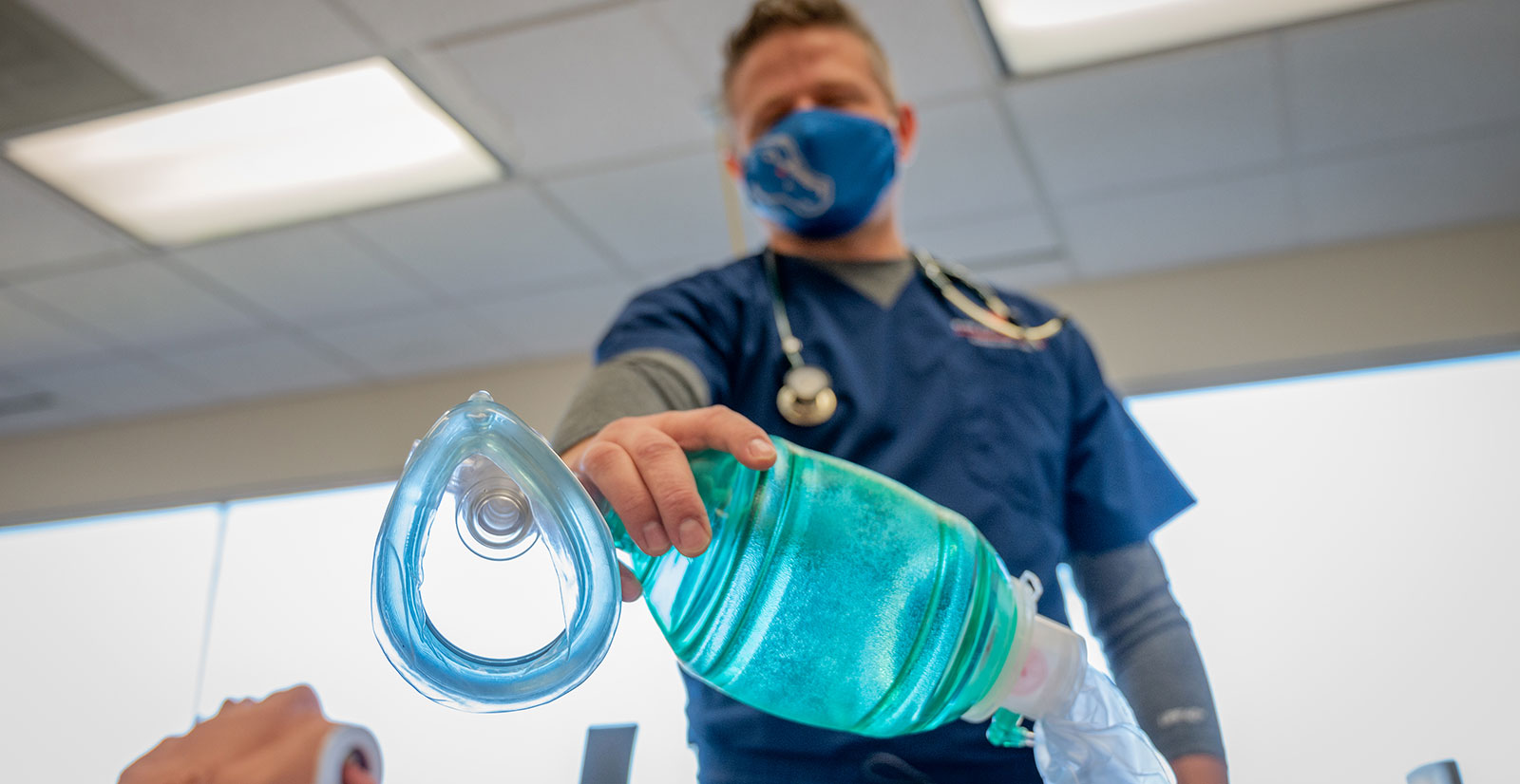 Respiratory Care student holds an oxygen mask to camera