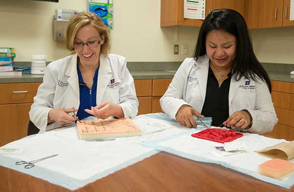 AGNP students practice suturing during on campus intensive