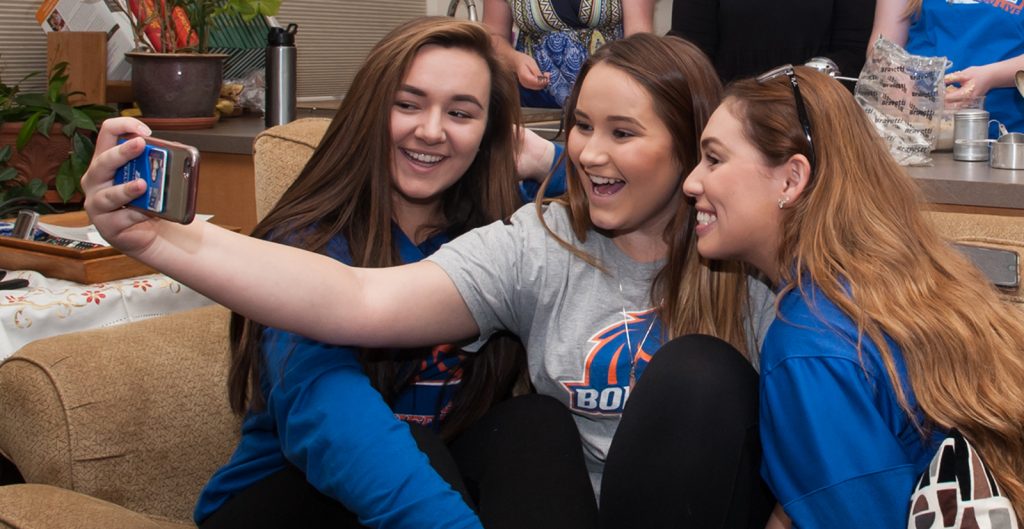 Boise State students take a selfie in a residence hall on campus