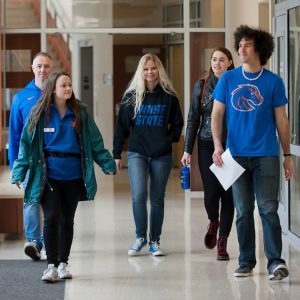 Boise State students walk through a residence hall on campus during Bronco Day