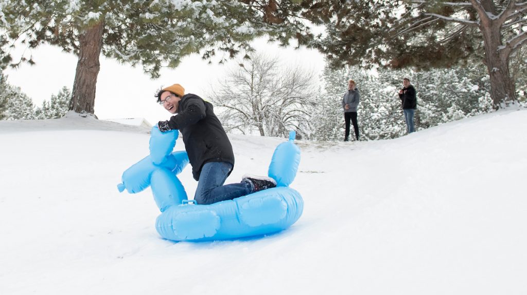 Students sledding in the snow