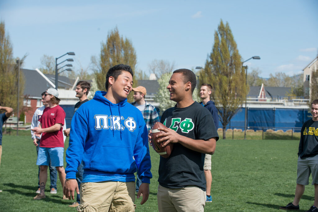 Students toss a football at a fraternity event