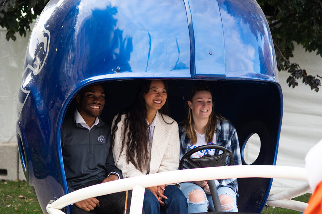 Chey and other ASBSU leaders pose in the Boise State helmet cart.