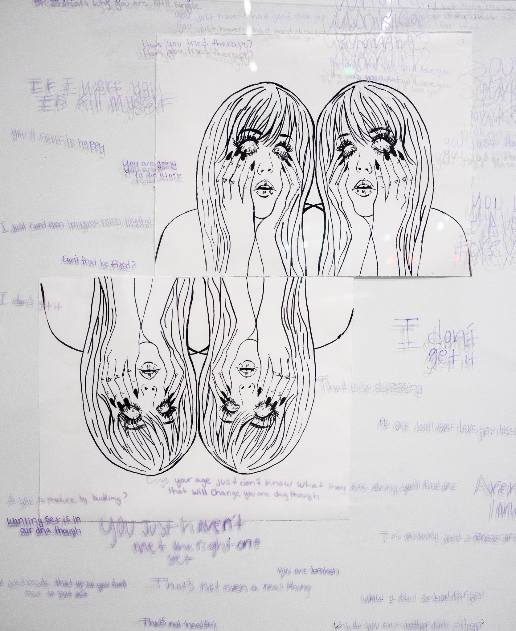 Printmaking installation with written words over white background and paper printed with black and purple illustration of a female with head in hands, eye rolling back.