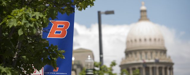 Photo of Idaho Capitol in background with Boise State Banner in foreground