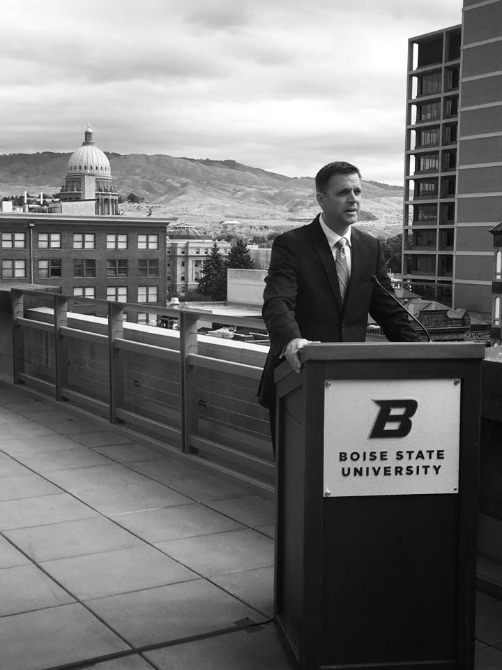Greg Hill at Boise State Lectern with Capitol Building in background