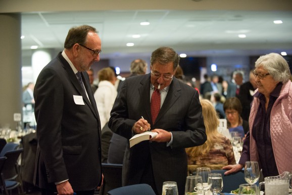 Leon Panetta signs autograph for attendee