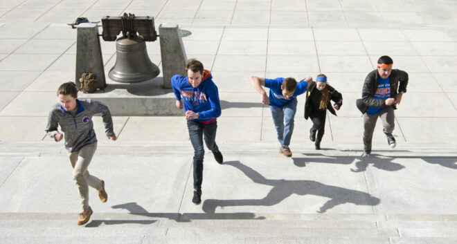 Students running up the Idaho Capitol steps