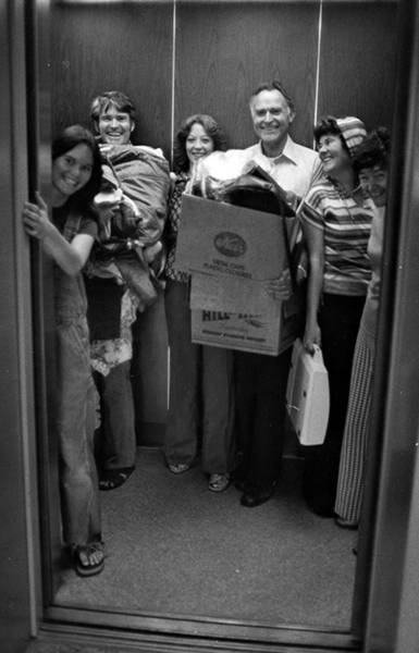 Family using elevator to transport things to a residence hall in the 1970s