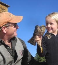 Greg with his daughter looking at a Cooper's Hawk