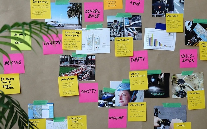 User Experience Design workshop with board of sticky notes, images, and graphs