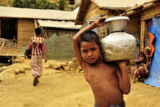 A child with clean water in a Rohingya camp