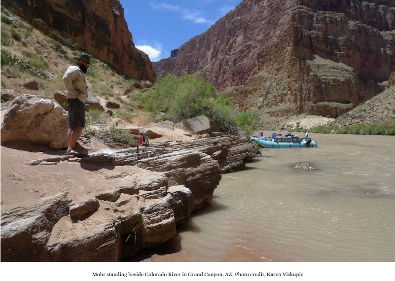 Mohr standing beside Colorado River in Grand Canyon, AZ. Photo credit, Karen Viskupic