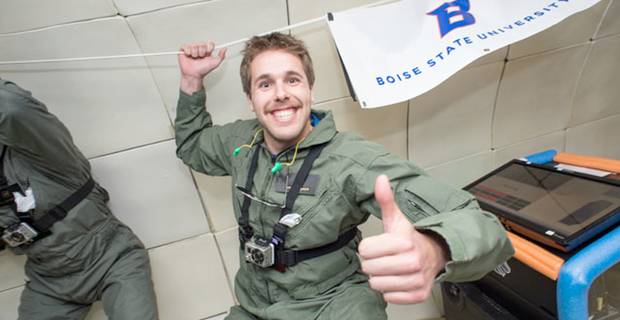 Microgravity Student Grinning in a Zero-Gravity chamber and giving a thumbs-up to the camera.