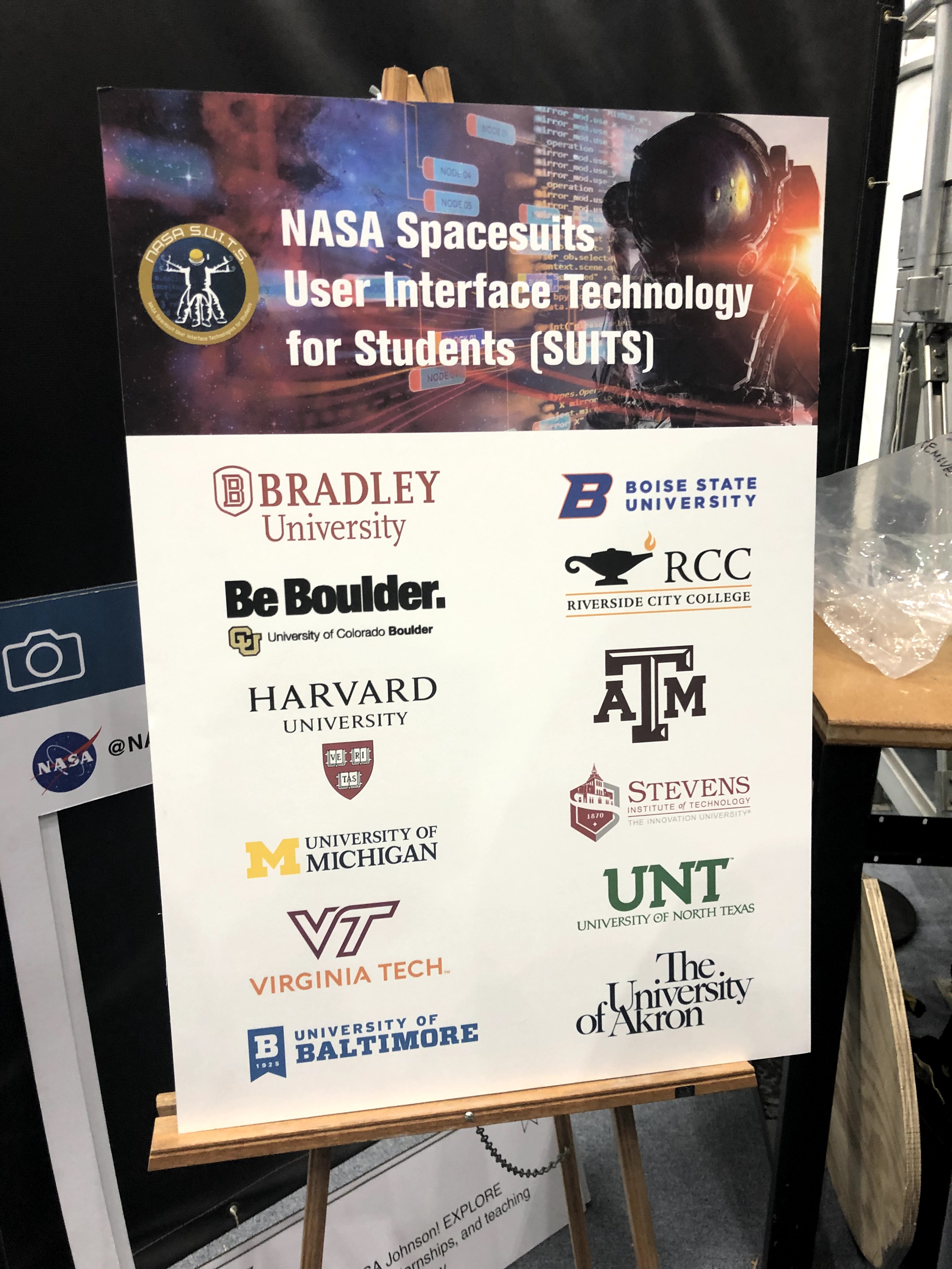 Image of Promotional Material at Johnson Space Center revealing the schools involved in the NASA Suits challenge. Boise State is listed among schools such as Harvard and Virginia Tech