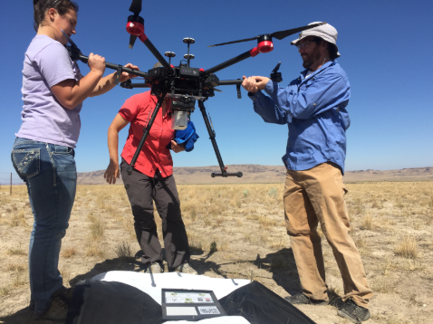 Team members handling and setting up large drone