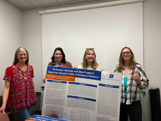 Boise State Students holding a research poster depicting their work