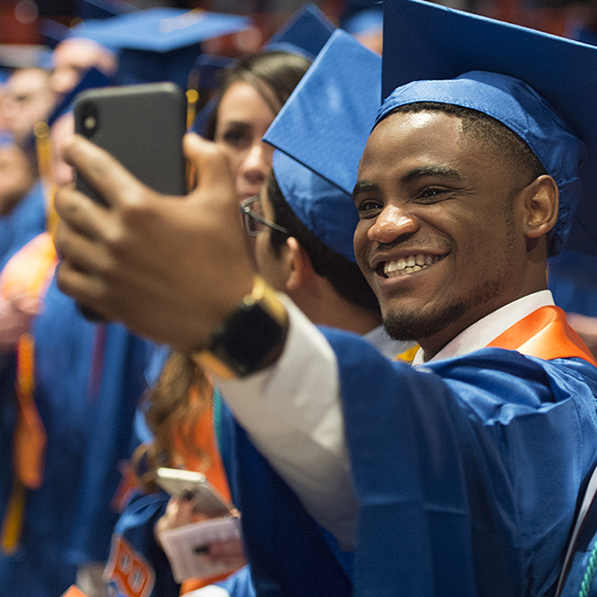 Graduates take selfie at graduation ceremony