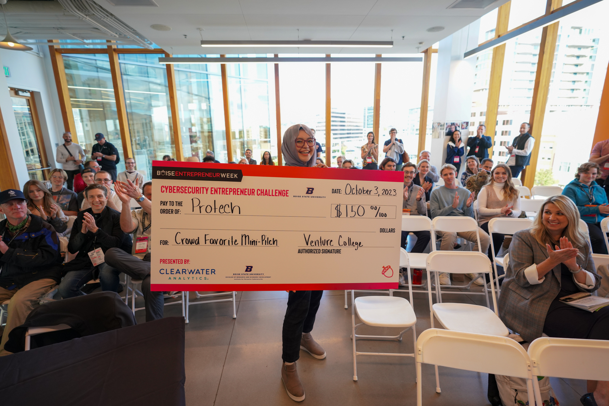 Cybersecurity Entrepreneur Challenge Winner 2023, Olima, with Check in front of Crowd