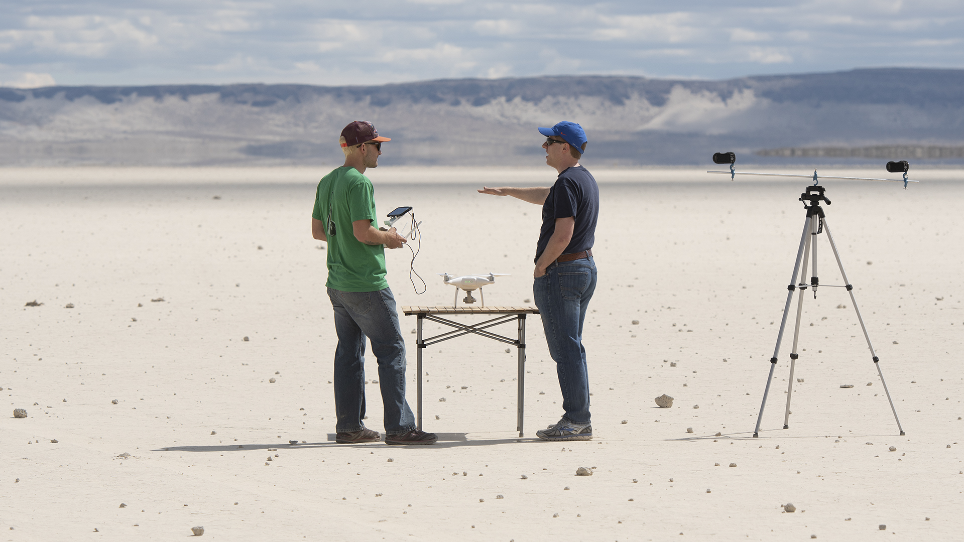 Researchers in dessert standing next to all the equipment