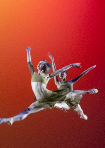 Dancers leaping through air on stage