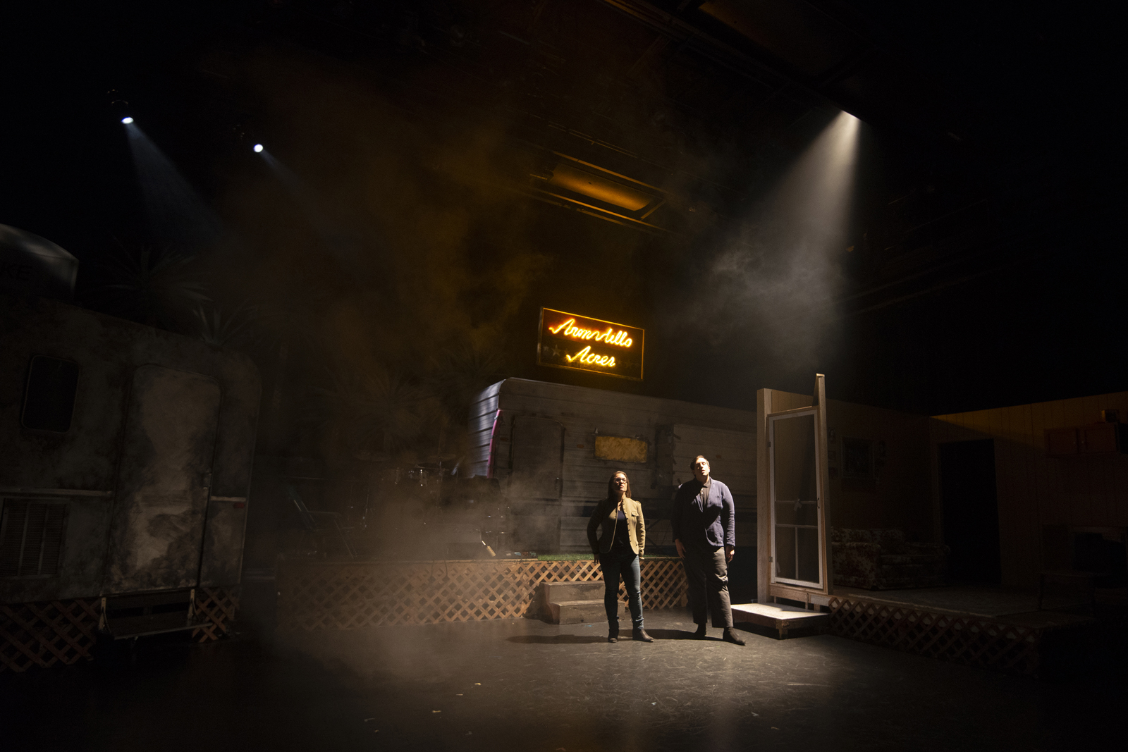 Two actors on a dark stage and spotlight
