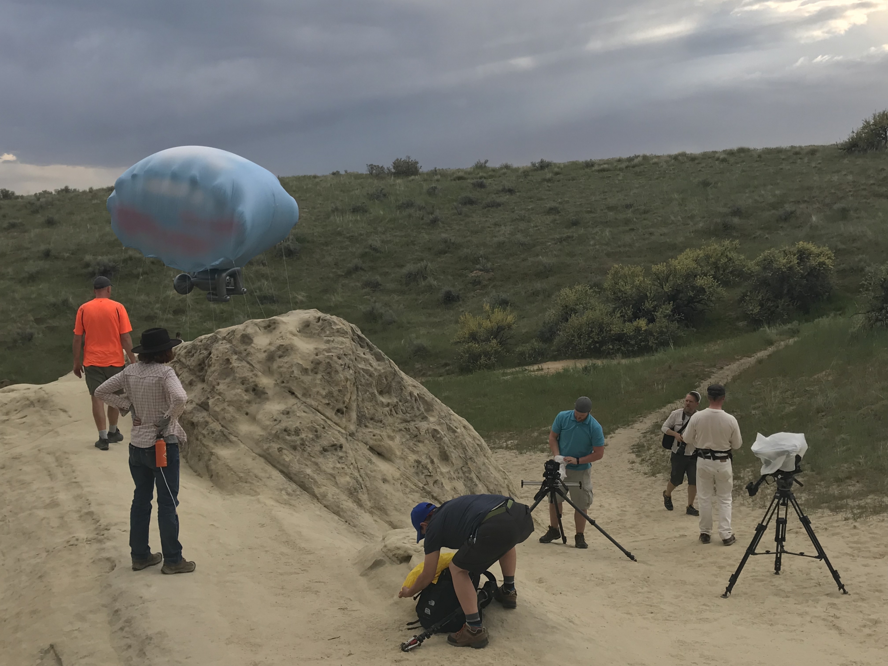 Camera crew setting up around Cloudship performance art in the Boise foothills