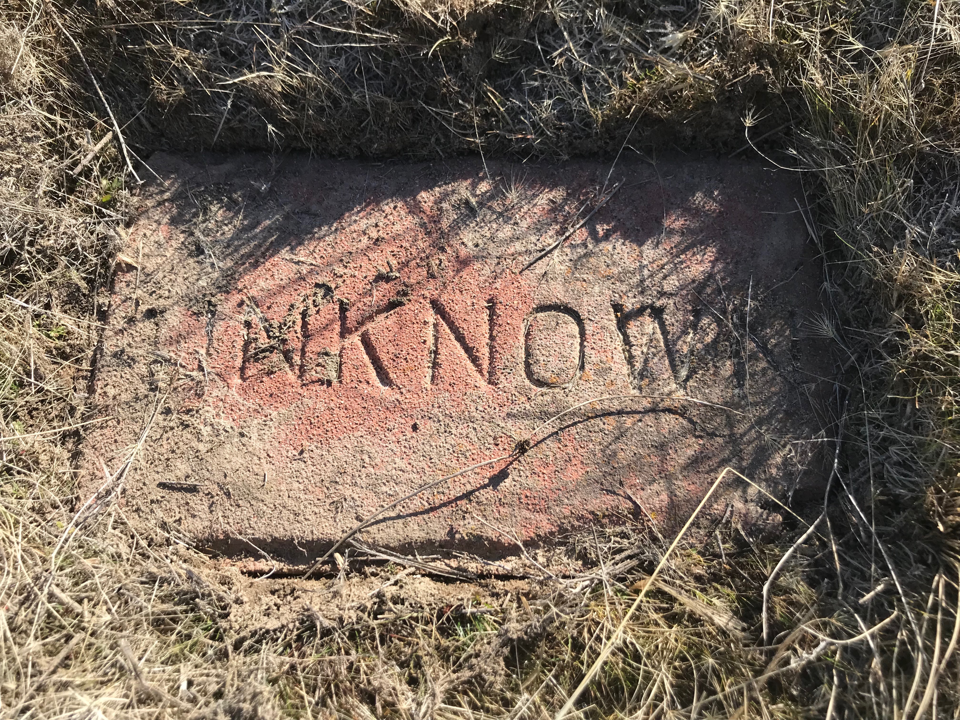 a stone marker from the Old Penitentiary cemetery. 
