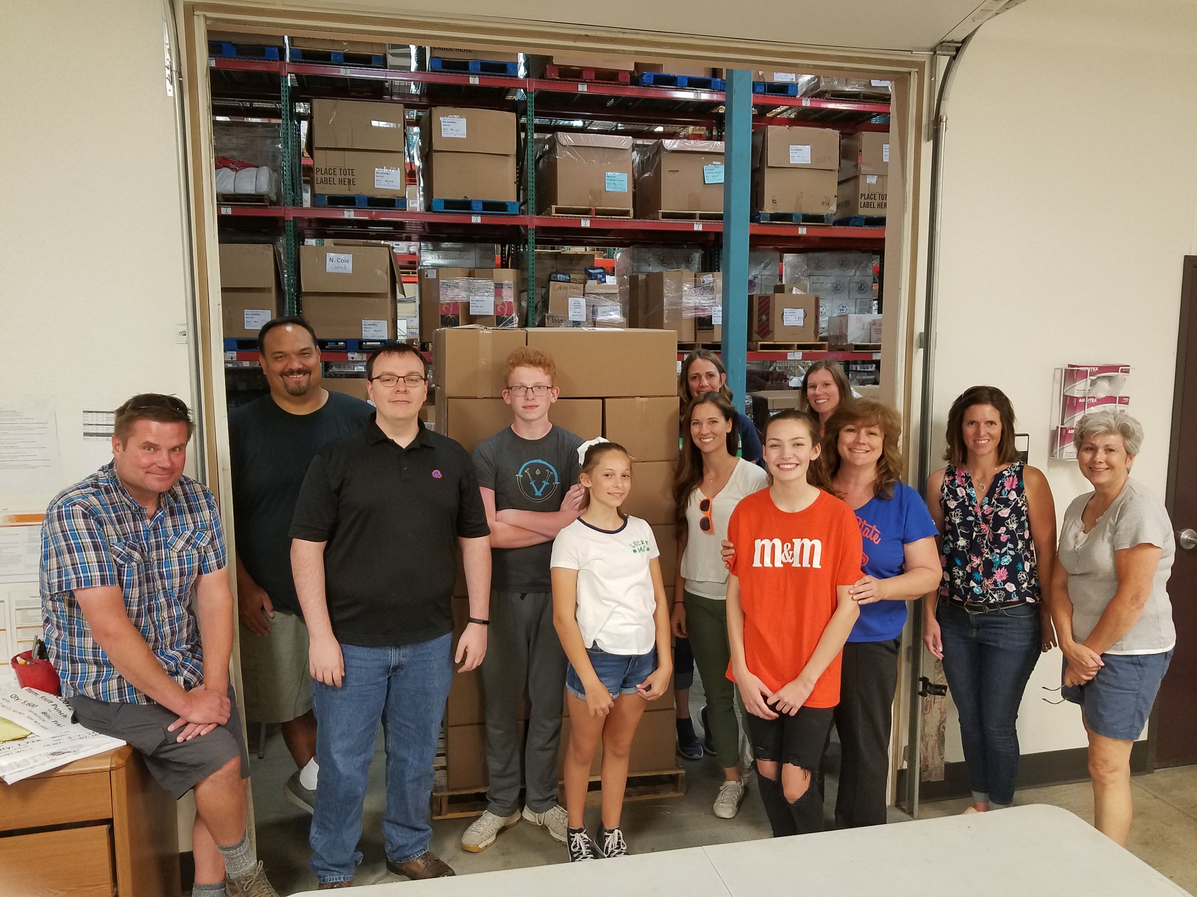 Boise State employees pose at the Idaho Food Bank while volunteering.