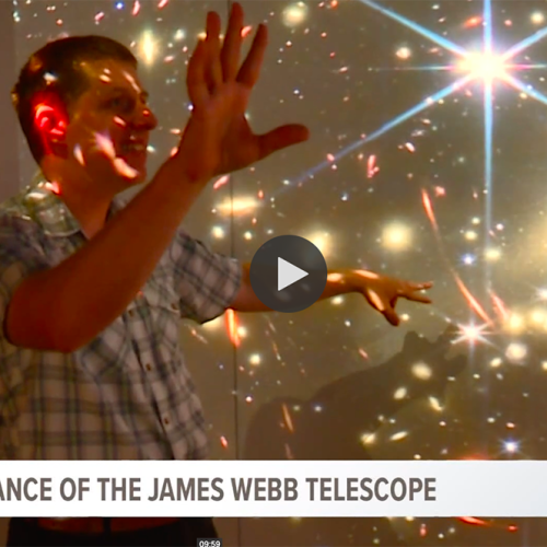 man surrounded by projections of stars