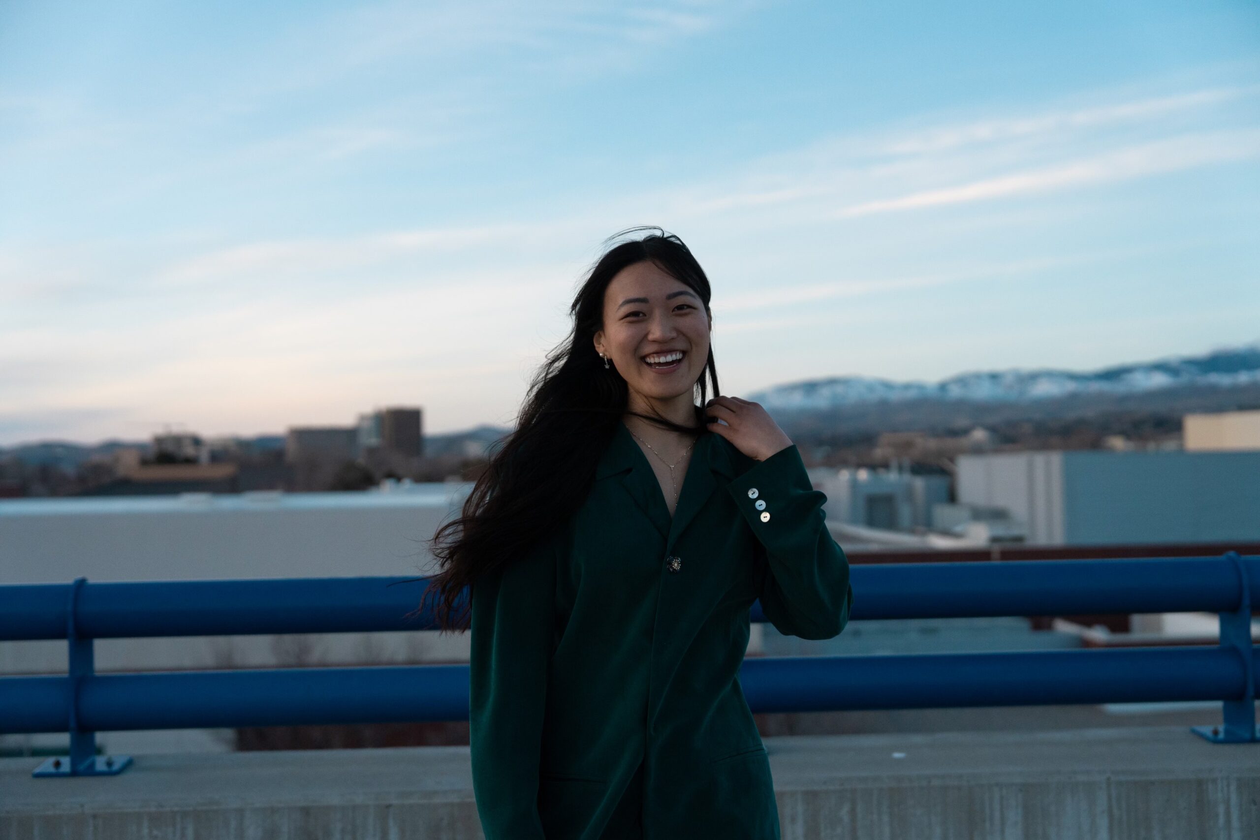 A picture of Cheyon Sheen, 2023 Truman Scholar, on top of a parking garage overlooking downtown Boise