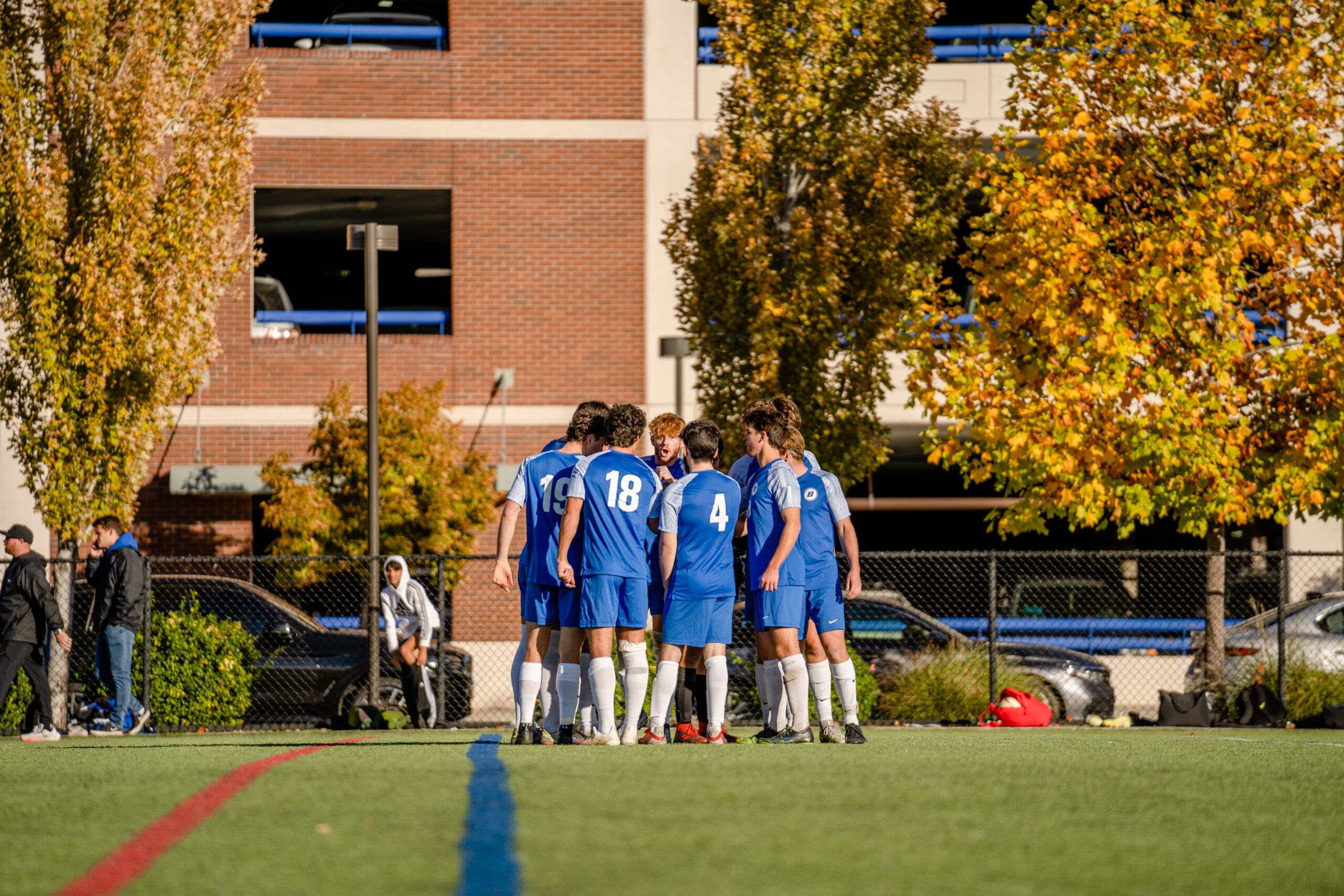 Zack Tyree on the soccer field with his teammates as the captain of Boise State men's soccer club