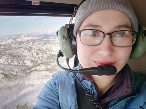 Karina wearing a headset in a plane