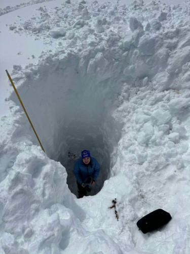Karina standing in an over 3 meter snow pit to analyze snow density at the Mores Creek study site north of Boise.