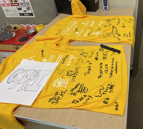 T shirts are signed by camp participants