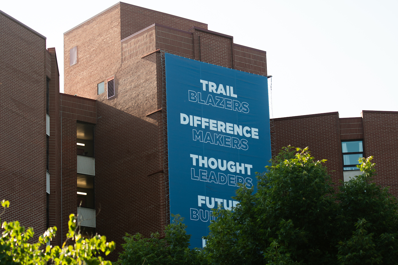 Blue marketing banner on brick building