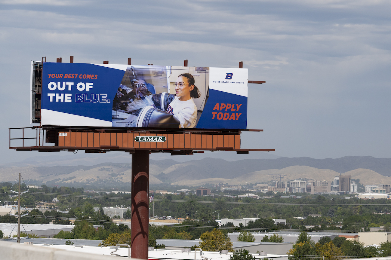 A billboard features a researcher