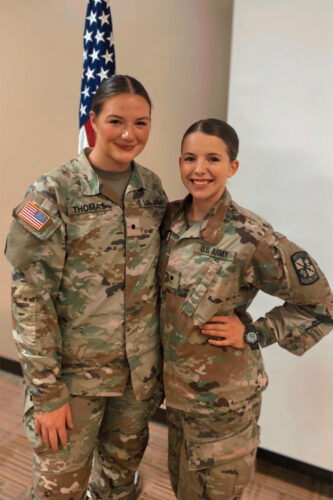 Colburn smiles in uniform with another Army nurse cadet.