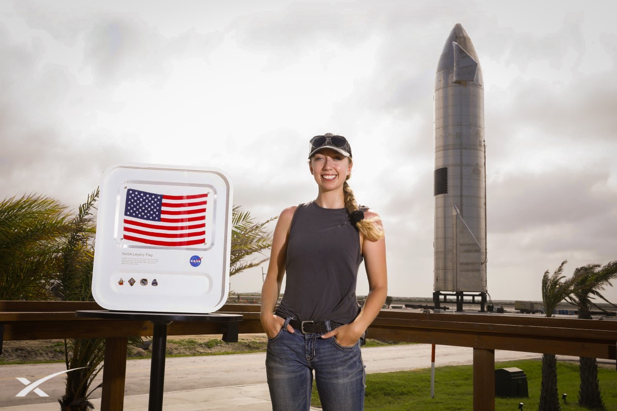 Catherine Gale posing in front of rocket ship.