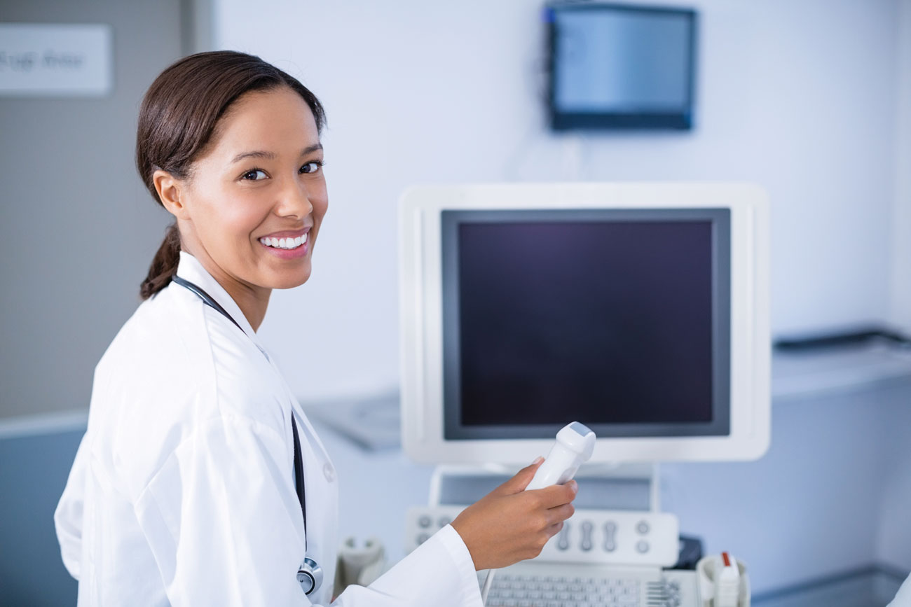 female ultrasound technologist holds equipment