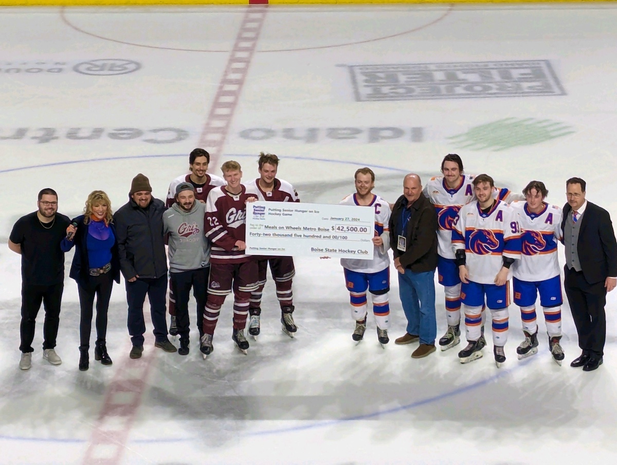 A hockey team poses with a novelty check