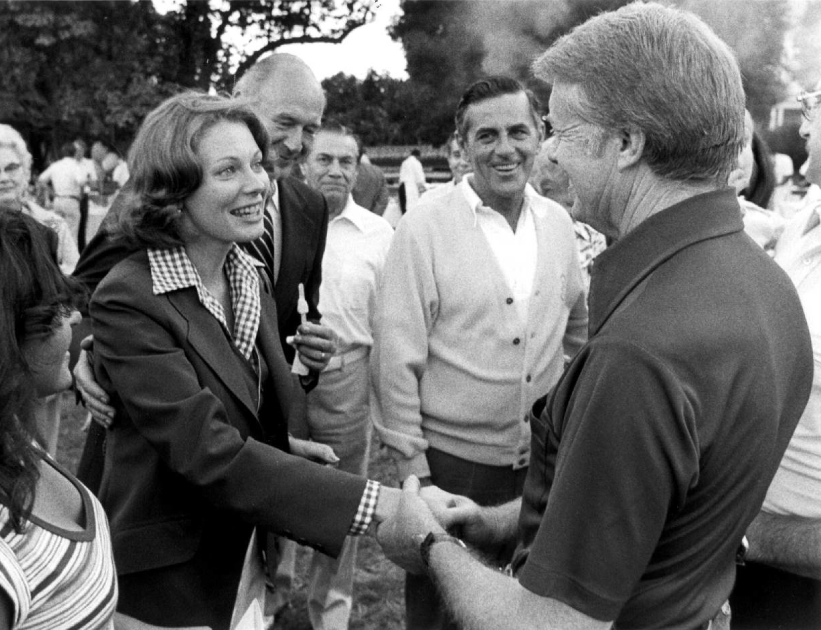 A black and white photo of Tracy Andrus shaking hands with President Jimmy Carter. 