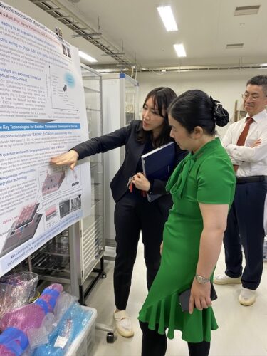 Two persons look at a research presentation board