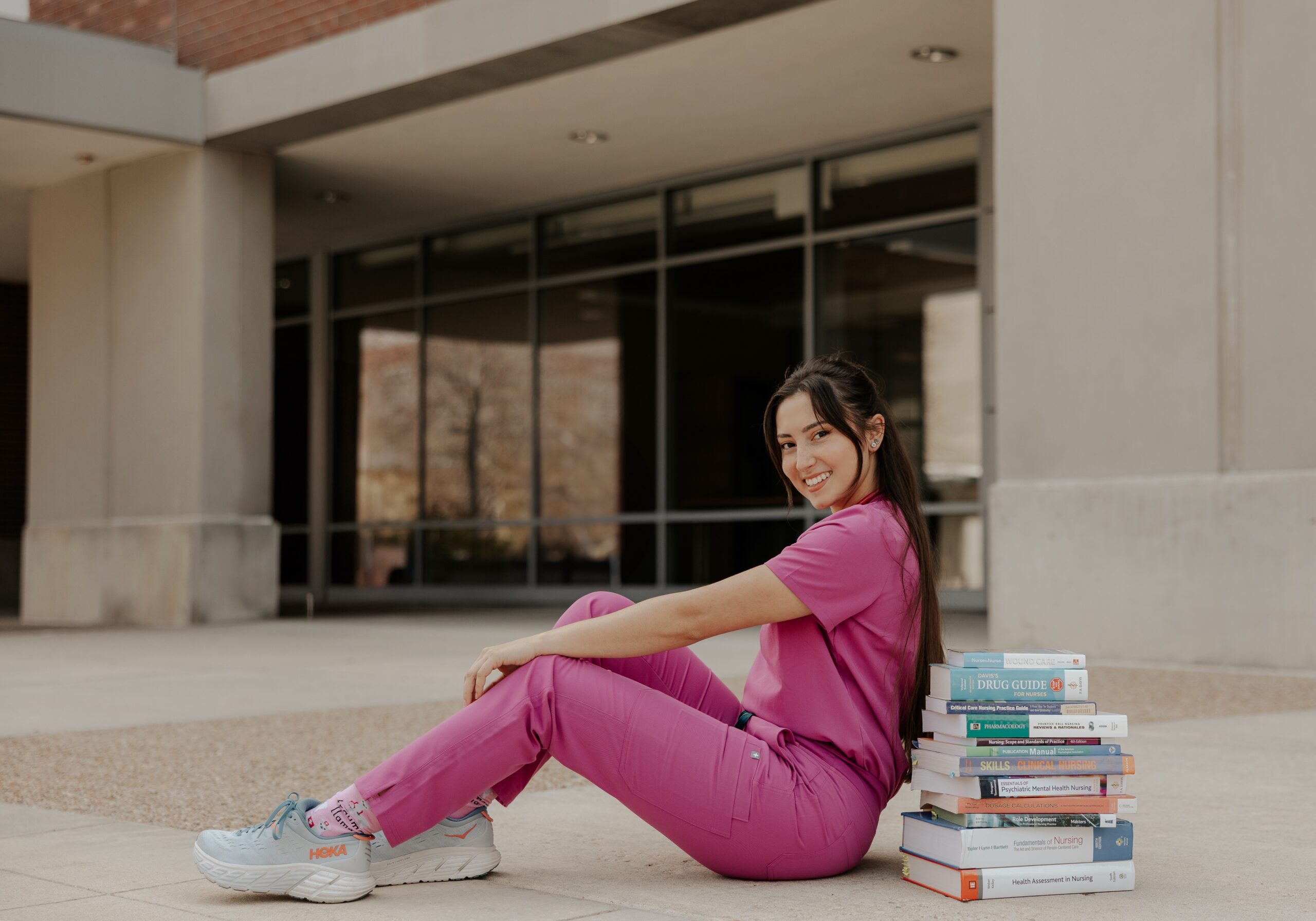 Nicolette Misbrenner poses on the Boise State campus with her textbooks