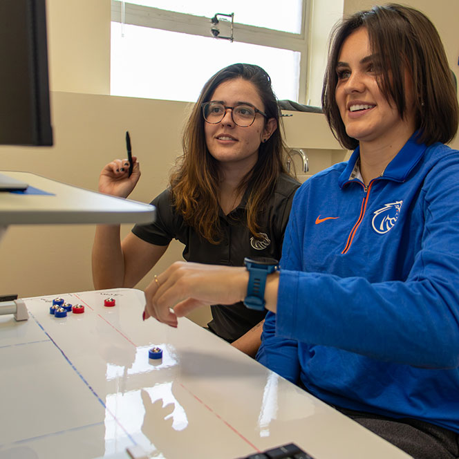 Faculty Mariane Bacelar and kinesiology master's student Jet Taylor study shuffleboard movement