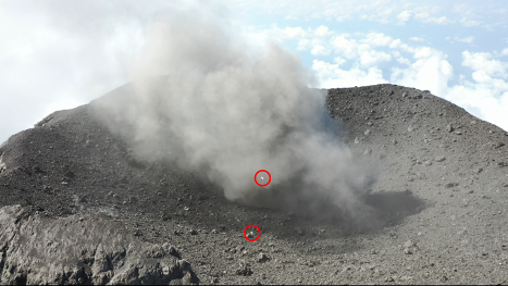 a close up of the active mouth of the volcano and twi small red circles highlighting drone package placement