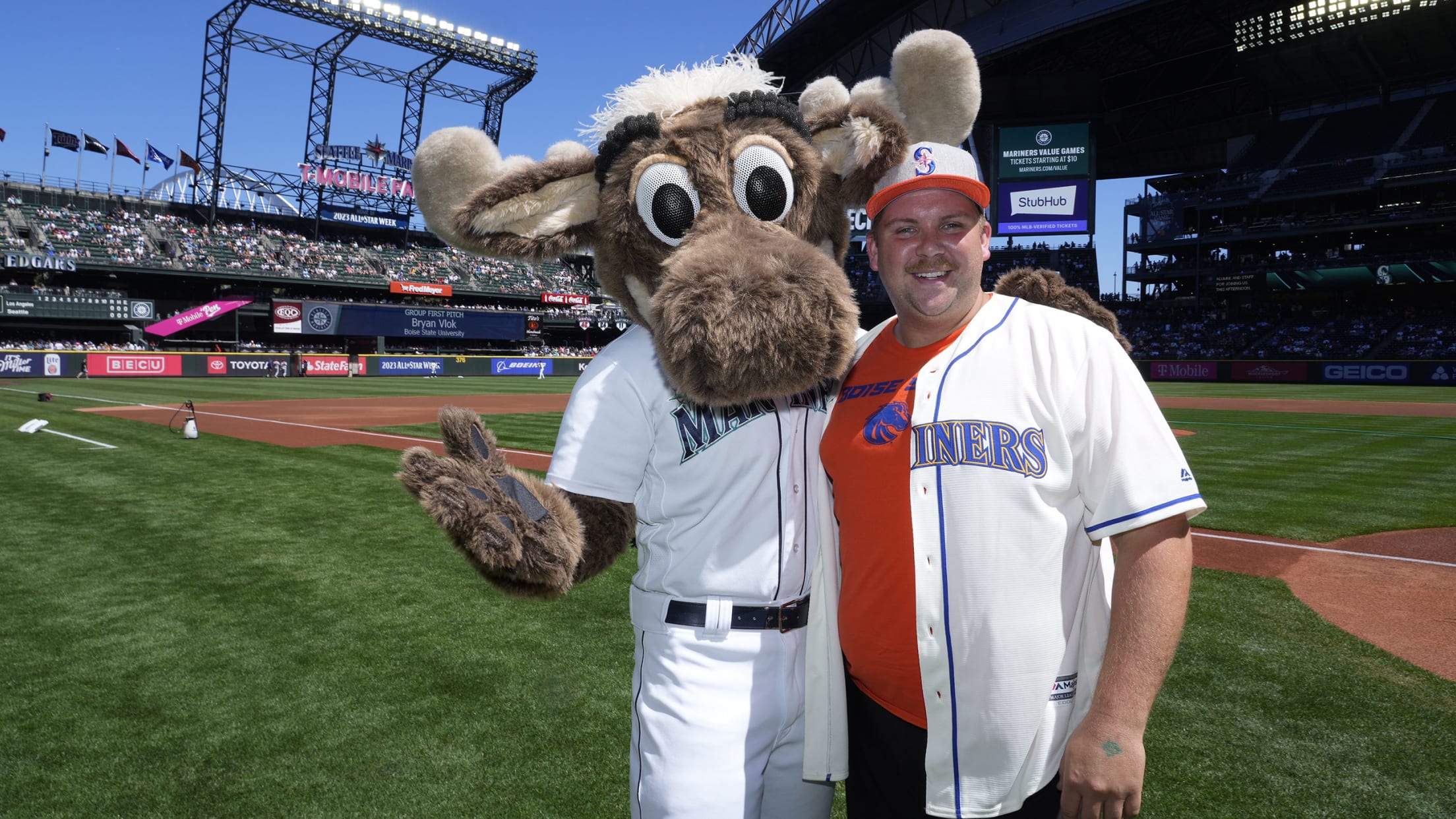 A Boise State alum at T-Mobile Park standing next to the Mariners mascot